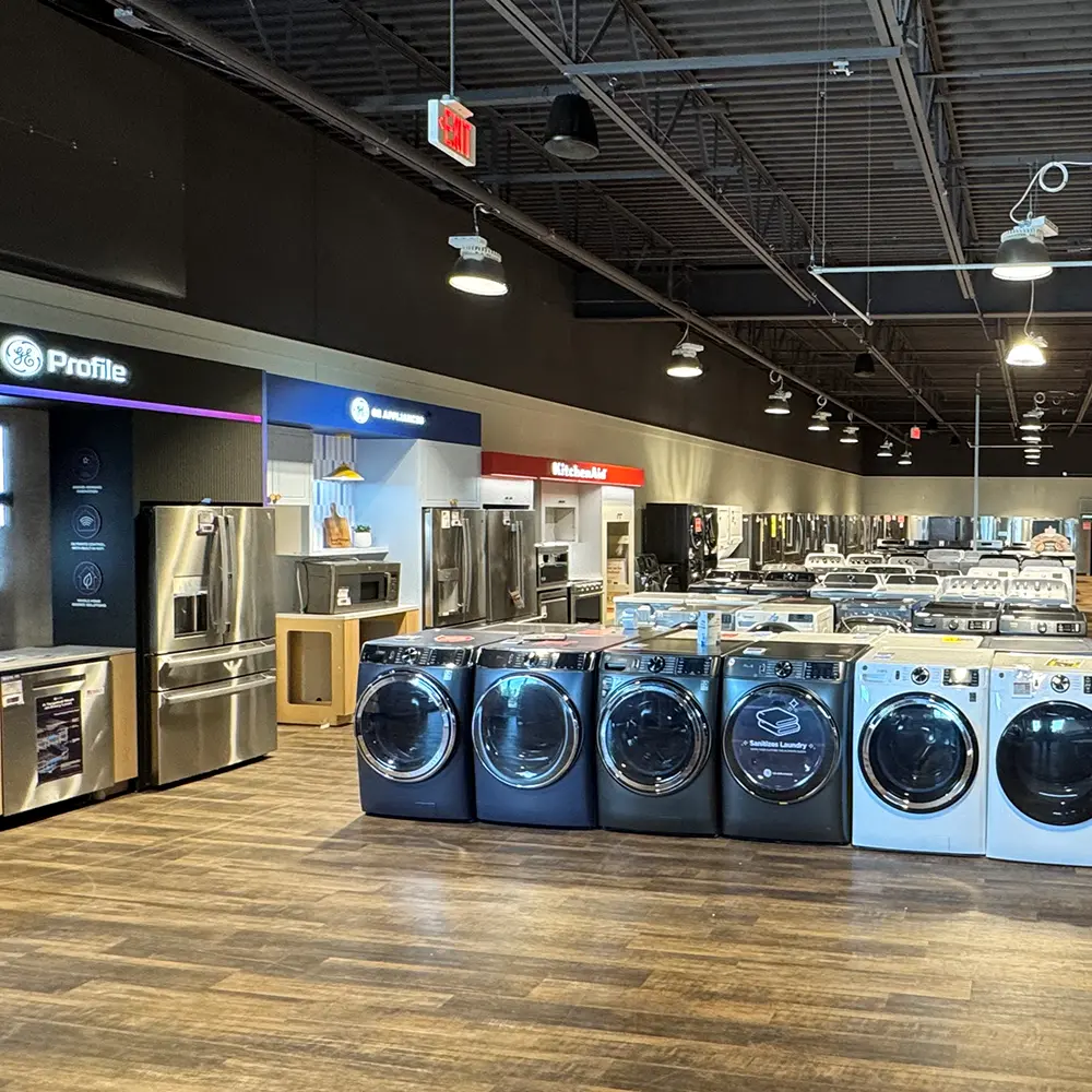 ABC Warehouse Saginaw appliance showroom featuring front-load washers, dryers, stainless steel refrigerators, ranges, and kitchen appliances from top brands on display.
