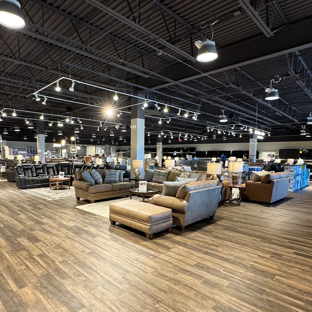 ABC Warehouse Saginaw furniture showroom featuring sofas, sectionals, recliners, ottomans, tables, and living room furniture arranged in a spacious retail showroom.